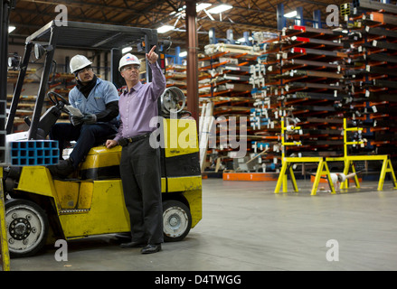 Worker and businessman in metal plant Stock Photo