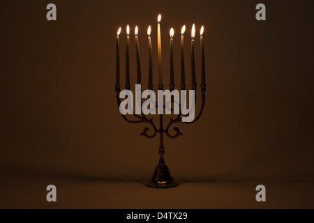 Menorah with lit candles Stock Photo