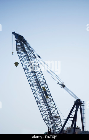 Silhouette of crane against sky Stock Photo