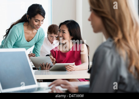 Businesswomen talking in office Stock Photo