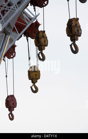 Hooks hanging from crane Stock Photo