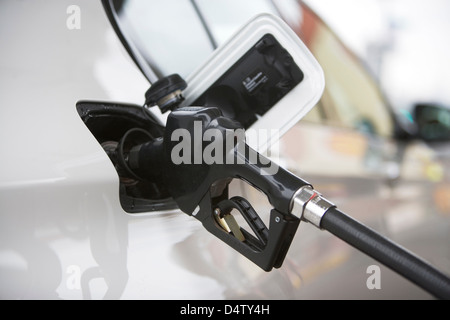 Close up of gas nozzle in tank Stock Photo