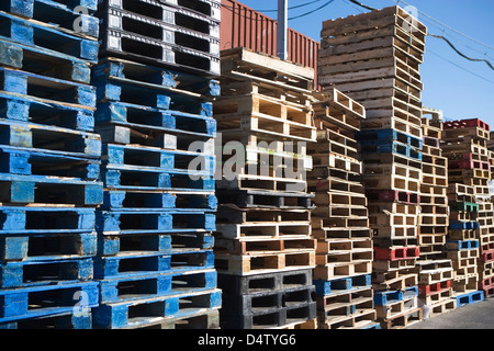 Pallets stacked together in yard Stock Photo