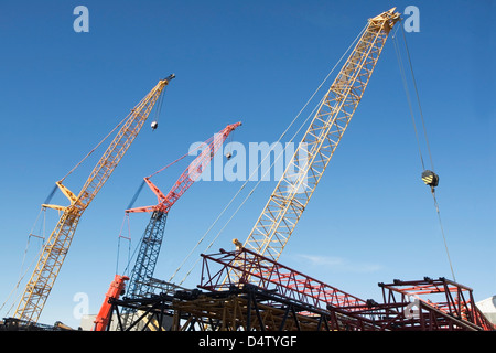 Colorful cranes against blue sky Stock Photo
