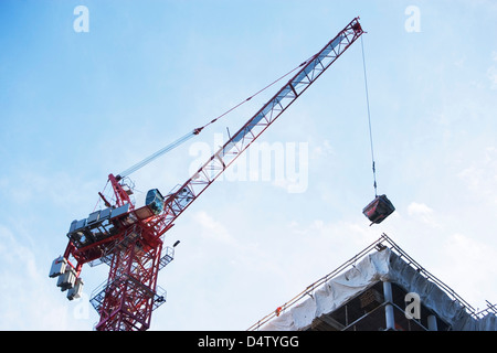 Crane loading equipment on building Stock Photo