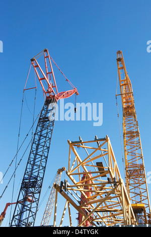 Colorful cranes against blue sky Stock Photo