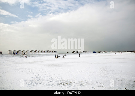 Snow and beach huts at the Green Sward, Goring, West Sussex, UK Stock Photo