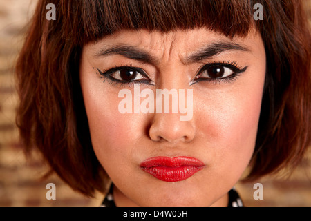 Close up of woman's frowning face Stock Photo
