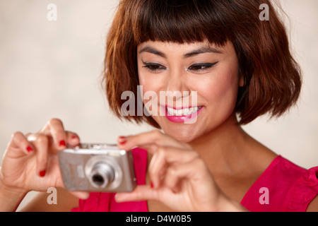 Smiling woman taking pictures Stock Photo