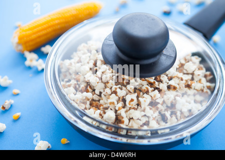 delicious homemade popcorn in a pan under the transparent cover, food Stock Photo
