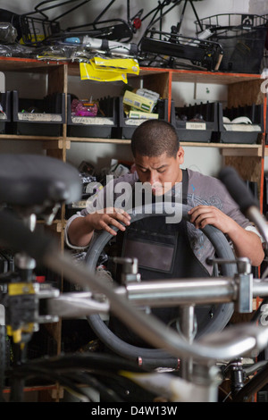 Mechanic working in bicycle shop Stock Photo