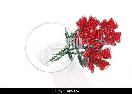 Three red beaded roses in a glass vase Stock Photo