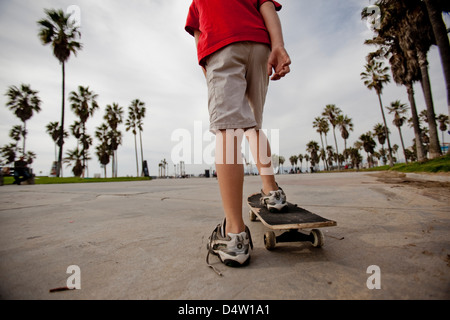 Boy riding on skateboard in park Stock Photo