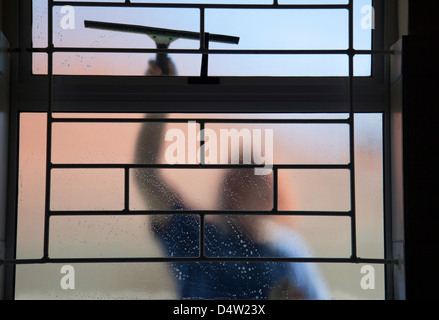 Person Cleaning Windows from outside Stock Photo