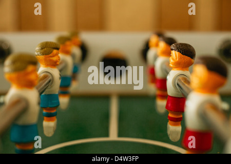 Close up of players on foosball table Stock Photo