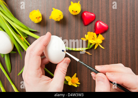 Painting Easter Egg on Table Stock Photo