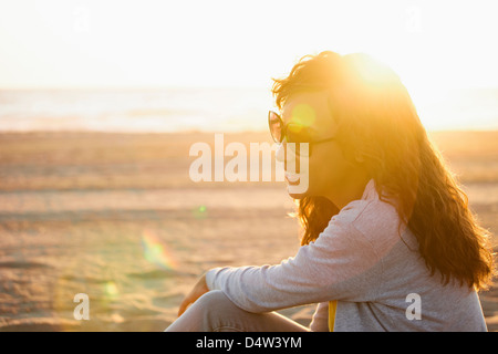 Smiling woman in sunglasses on beach Stock Photo