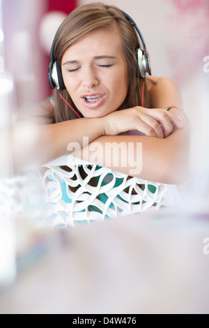 Teenage girl listening to headphones Stock Photo