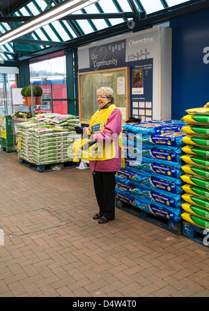 Woman collecting for Marie Curie Cancer Care charity in forecourt of supermarket. Stock Photo