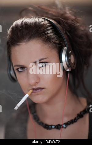 Teenage girl in dark makeup smoking Stock Photo