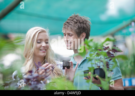 Couple shopping for plants in nursery Stock Photo