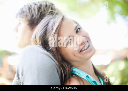 Smiling girl leaning on boyfriend Stock Photo