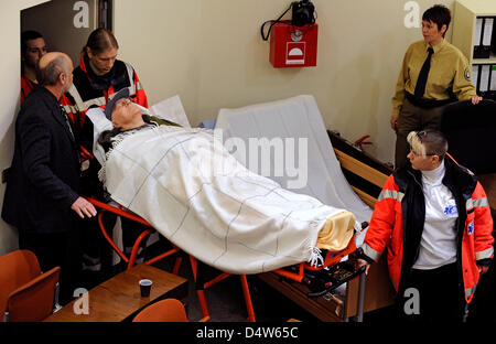 John 'Iwan' Demyanyuk, the former guard of the German extermination camp in Sobibor who is accused of accessory to murder, is transported on a mobile stretcher by nurses into the hall 101 of the District Court in Munich, Germany, 22 December 2009. Photo: JOERG KOCH Stock Photo
