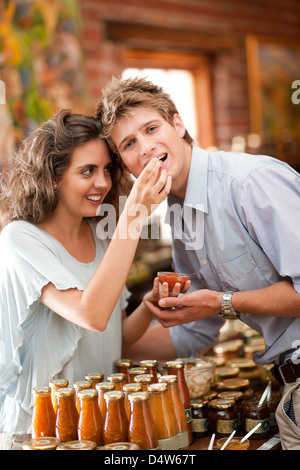 Couple tasting preserves in grocery Stock Photo