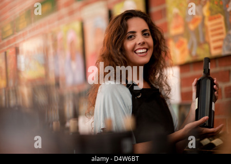 Server holding glass of wine in grocery Stock Photo