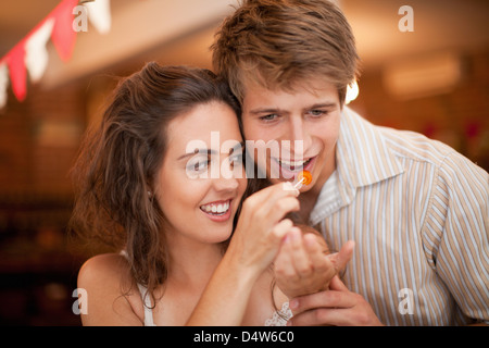 Couple tasting olives in grocery Stock Photo