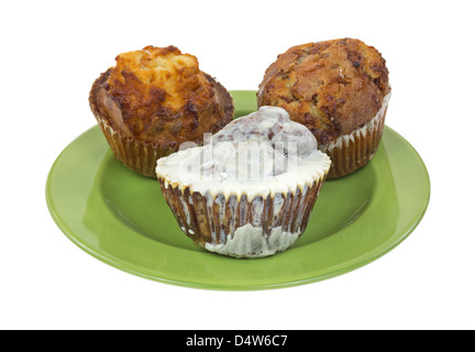 Pumpkin spice iced muffin with a butter rum and French toast muffin on a green plate. Stock Photo
