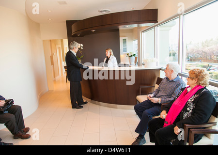 Patients in doctor's waiting room Stock Photo