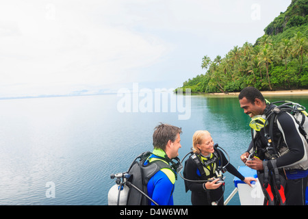 Scuba divers talking on boat Stock Photo