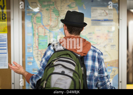 Confused man reading city map Stock Photo