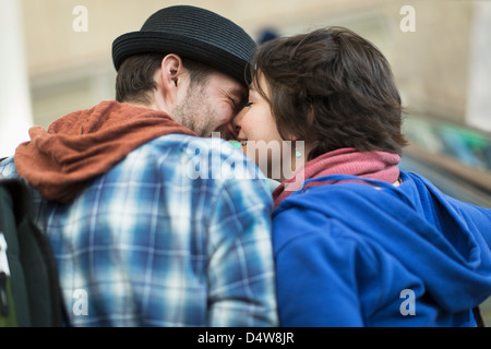Couple kissing on escalator Stock Photo