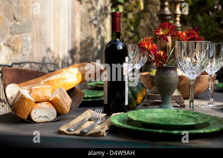 Bread and wine at set table Stock Photo
