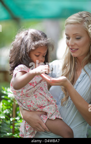 Mother holding daughter outdoors Stock Photo