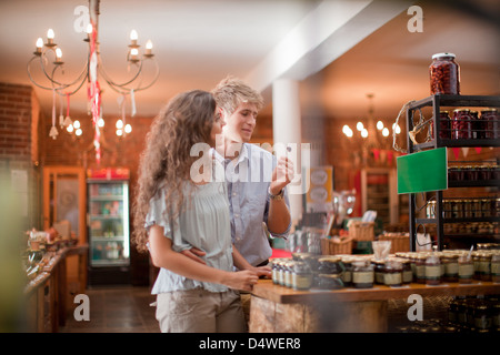 Couple tasting olives in grocery Stock Photo