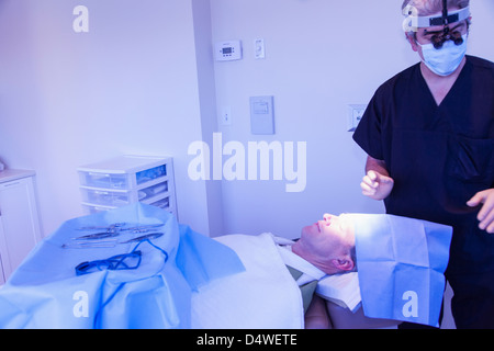 Surgeon with patient in operating room Stock Photo