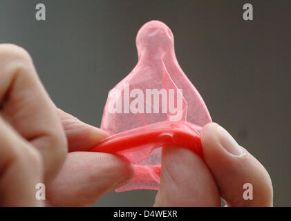 (file) -  A dpa file picture dated 29 November 2005 shows a red condom in Cologne, Germany. According to Brandenburg's Health Minister Anita Tack, people underestimate the danger of HIV infections. Photo: Oliver Berg Stock Photo