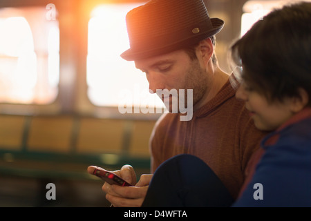 Couple using cell phone together Stock Photo