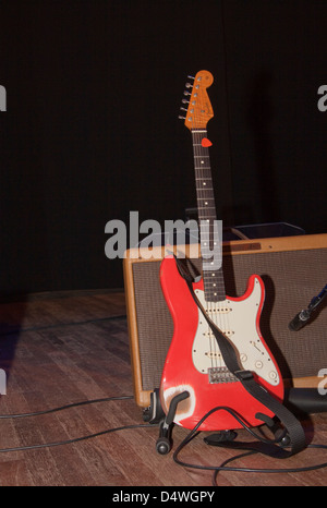 red electric guitar on a stand isolated on white background Stock Photo -  Alamy