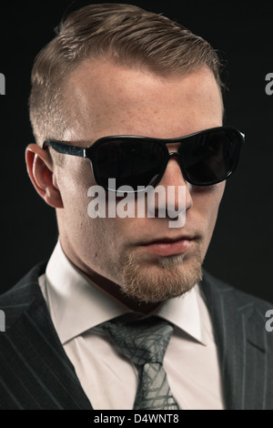 Fashion man in suit wearing sunglasses. Studio shot. Stock Photo