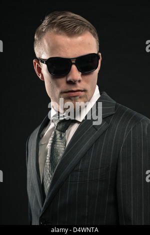 Fashion man in suit wearing sunglasses. Studio shot. Stock Photo