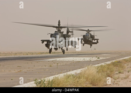 Two AH-64 Apache helicopters prepare to land on the active runway at COB Speicher, Tikrit, Iraq. Stock Photo