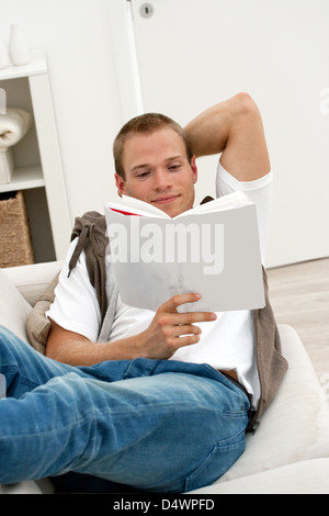 Handsome casual young man reading a book Stock Photo
