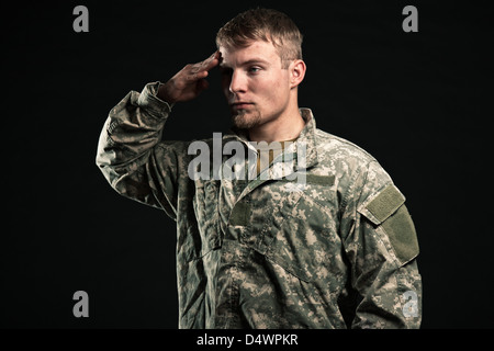 Military young man salutes. Studio portrait. Stock Photo