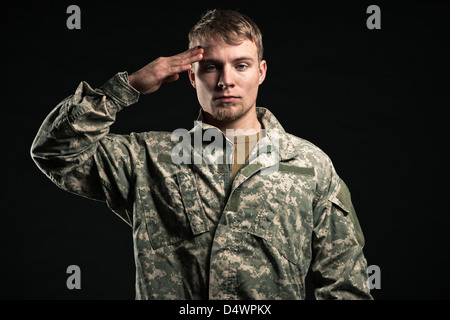 Military young man salutes. Studio portrait. Stock Photo