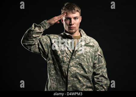 Military young man salutes. Studio portrait. Stock Photo
