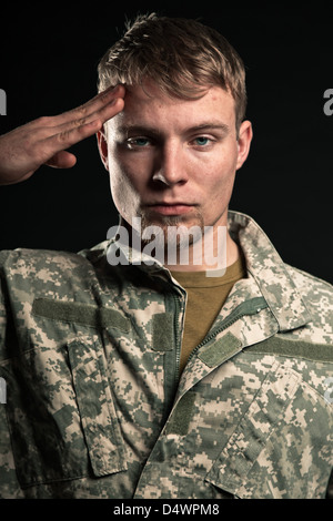 Military young man salutes. Studio portrait. Stock Photo
